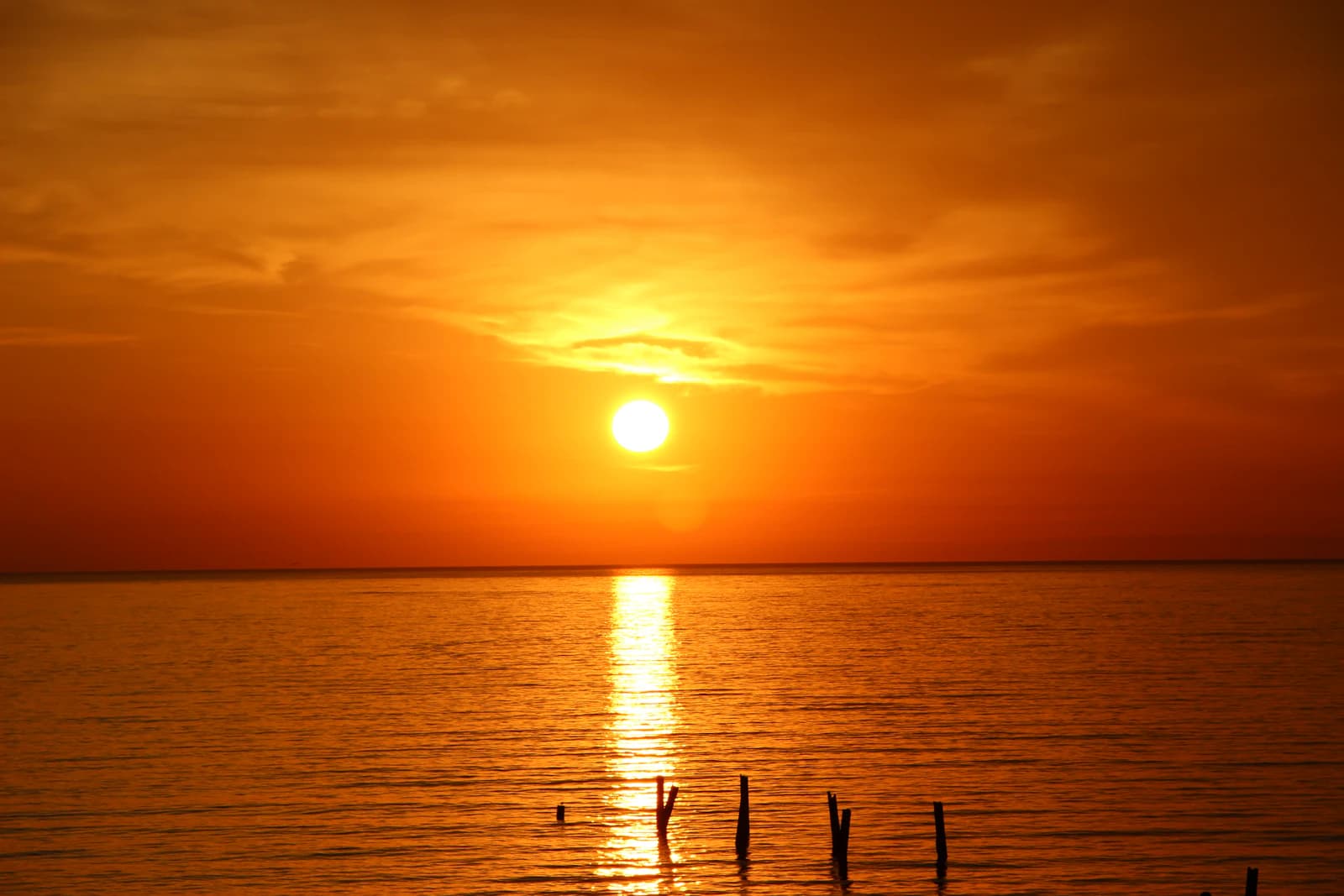 Sunset with a low sun casting a golden path across the sea