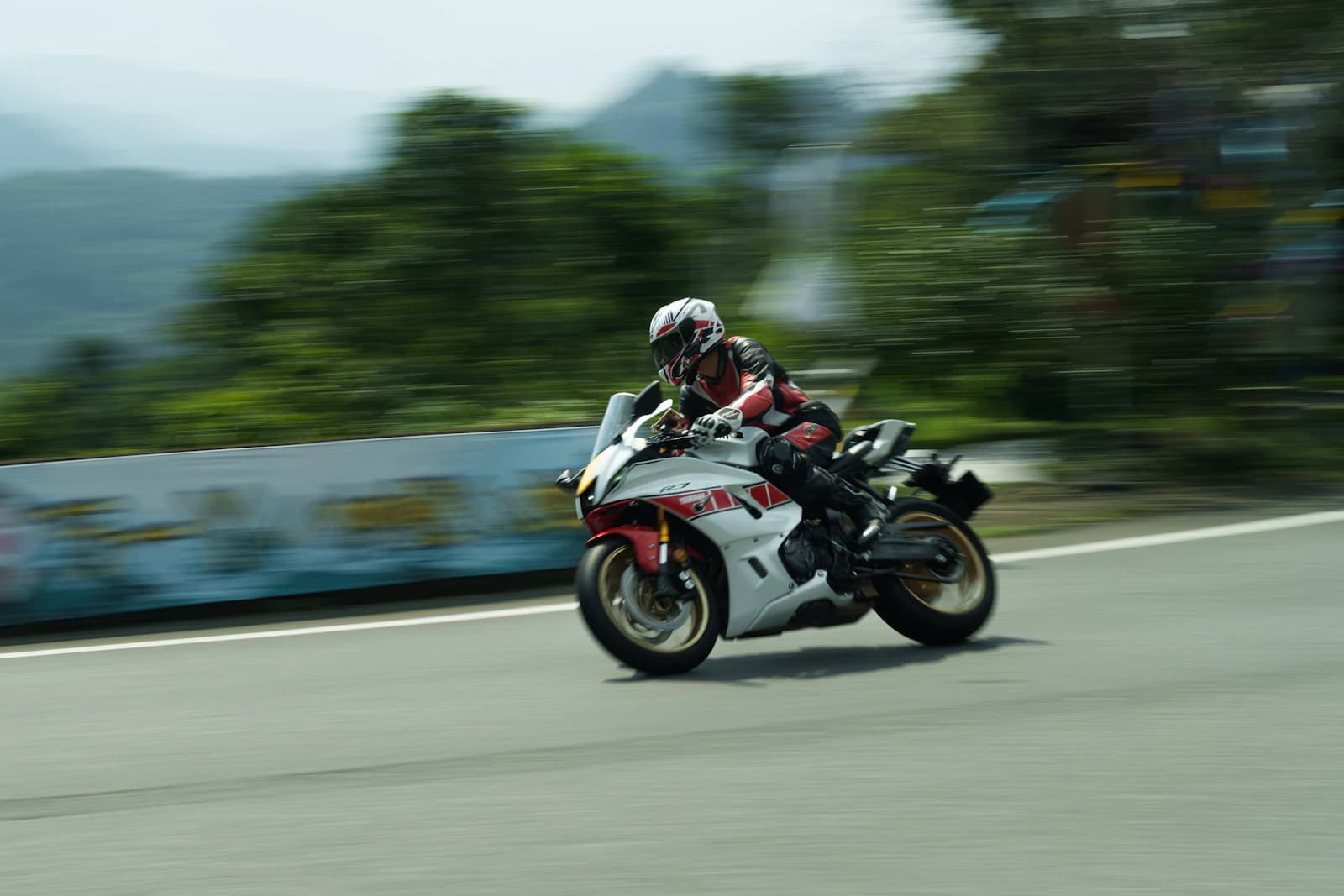 Motorcyclist captured with a panning technique and a streaked background